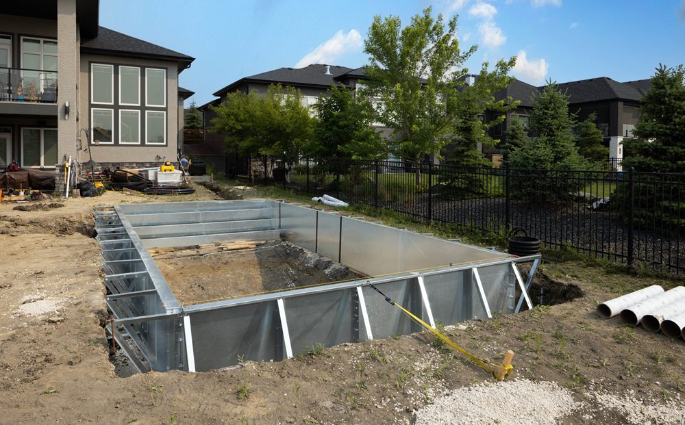 Ground-level view of a 14’ x 28’ steel pool kit in construction Ground-level view of a 14’ x 28’ steel pool kit in construction