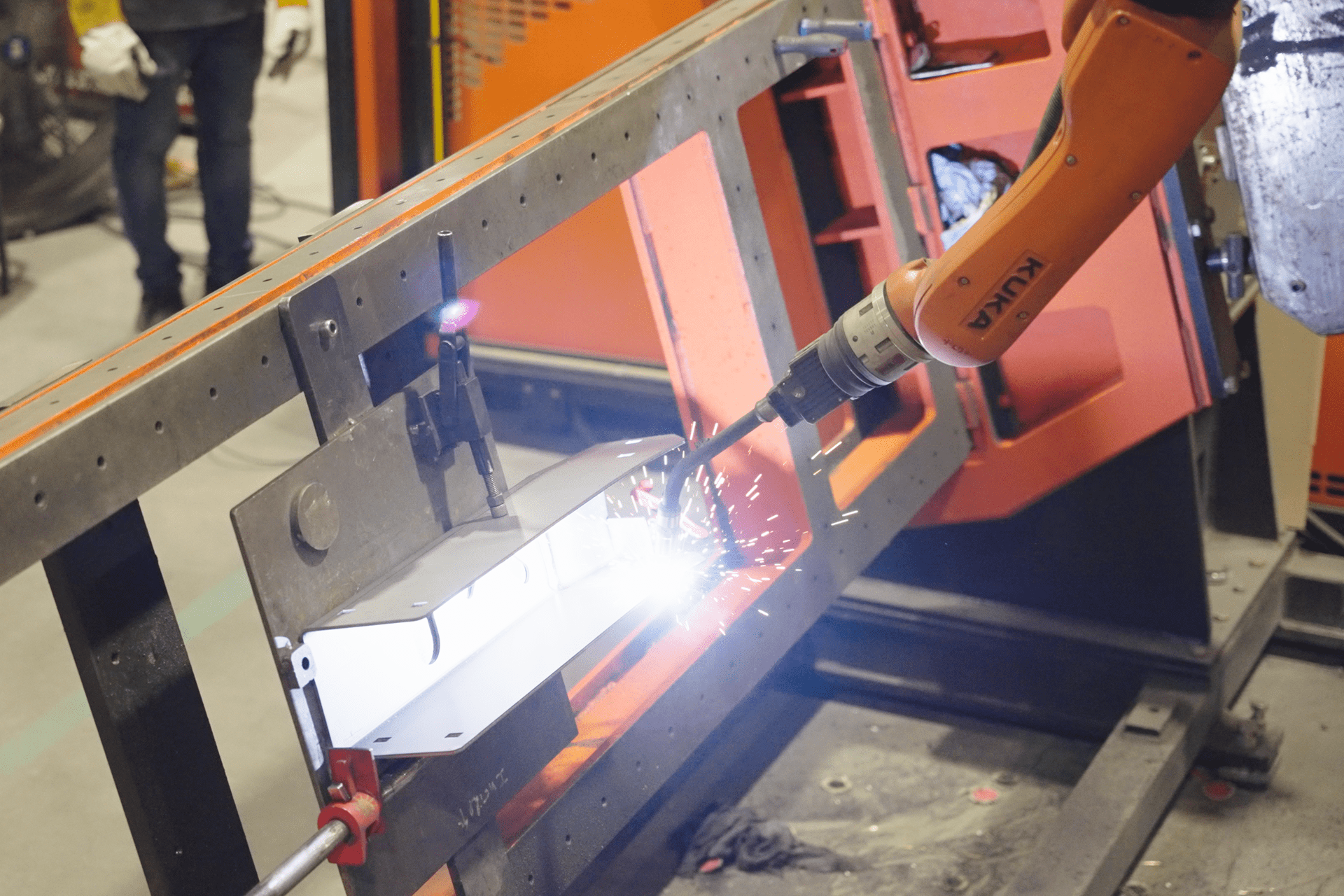 Part going through robotic welding Part going through robotic welding