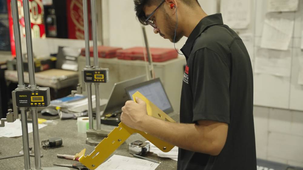Quality assurance being checked on part Quality assurance being checked on part